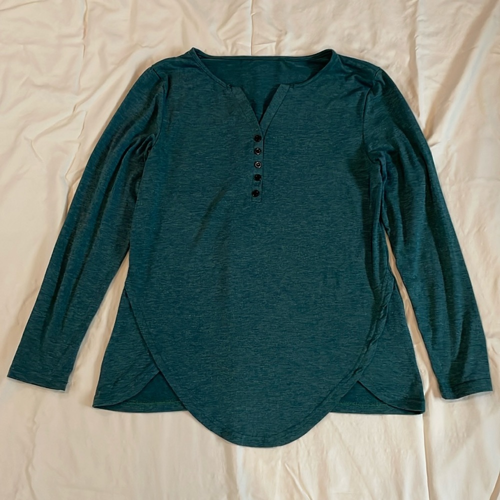 Women’s long sleeve pullover knit top. Has a v neck with 3 functional buttons.